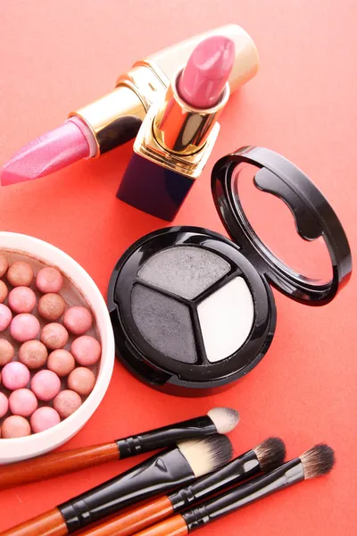 Many cosmetics on red background Stock Photo