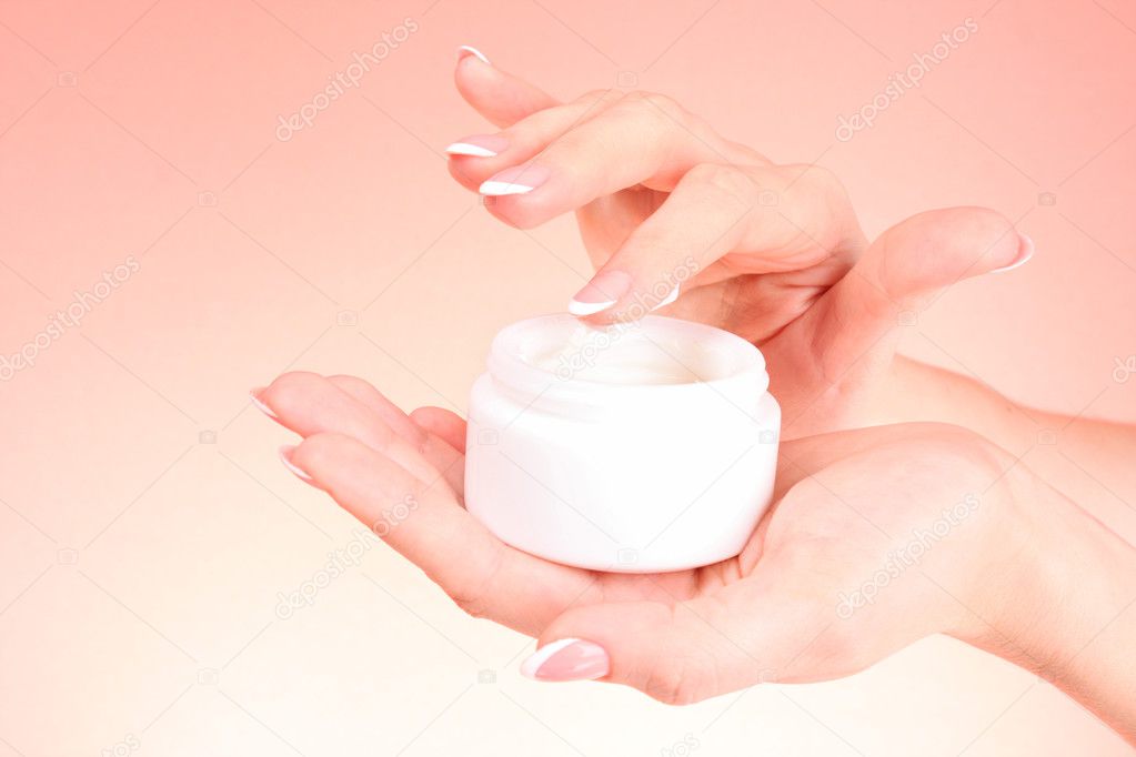 Woman hands holding a can of cream