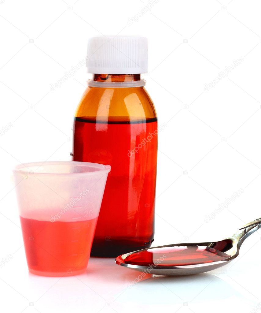 Cough medicine bottle with poured dose on counter