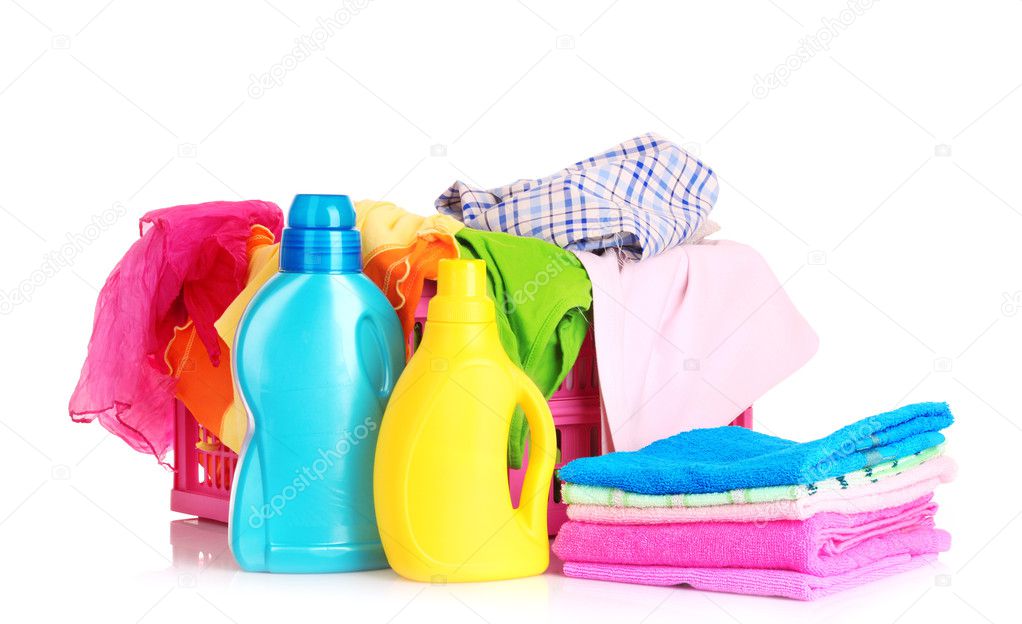 Bright clothes in a laundry basket and liquid laundry detergent