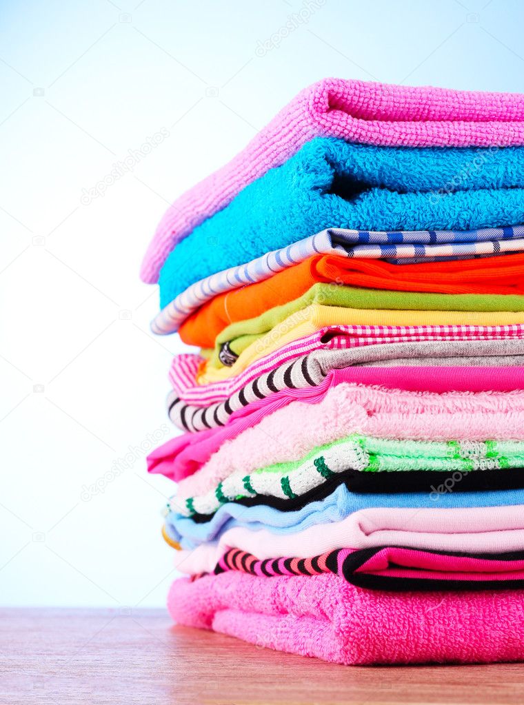 Pile of colorful clothes over blue background