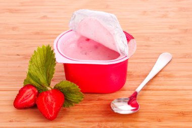 Yogurt and strawberry on a wooden background clipart