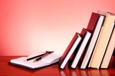 Stack of colorful books on the table clipart