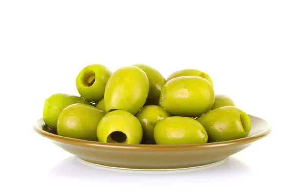 Зеленые оливки на тарелке изолированы на белом — стоковое фото