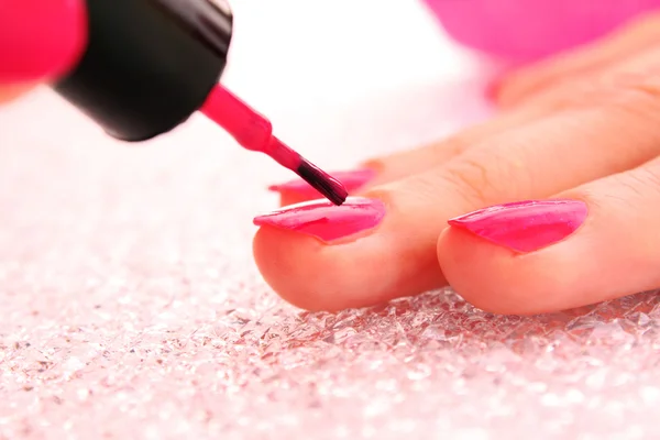 Woman applying pink nail polish — Stock Photo, Image