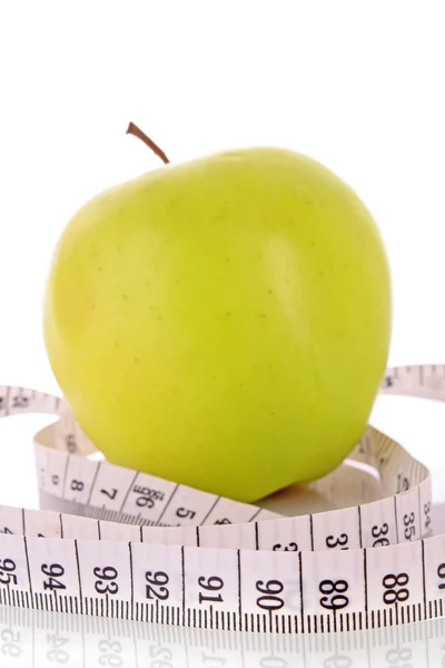 Manzana y una cinta métrica, concepto de dieta — Foto de Stock