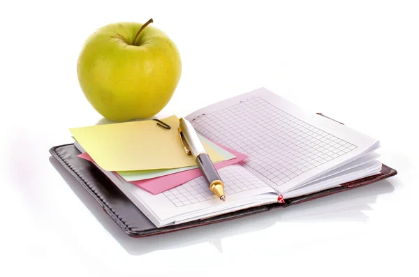 Open notebook with a pen on white — Stock Photo, Image