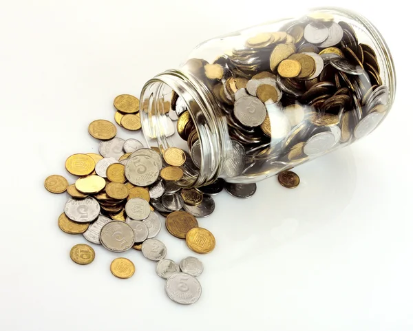 Coins spilling from a money jar — Stock Photo, Image