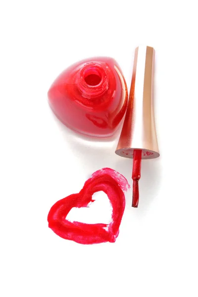 Red nail polish and heart on white background — Stock Photo, Image