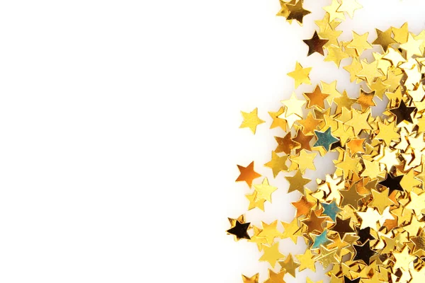 Estrelas douradas na forma de confete em branco — Fotografia de Stock