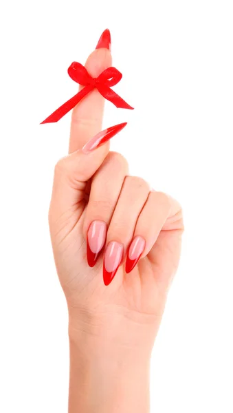 Pregos com esmalte vermelho e um arco no dedo — Fotografia de Stock