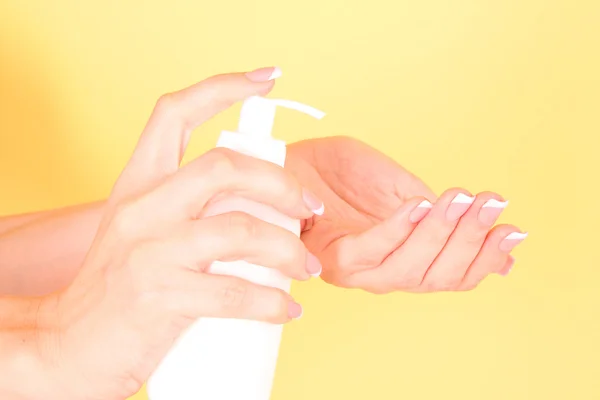 Woman applying cream on her hand — Stock Photo, Image