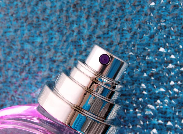 Perfume bottle on blue background — Stock Photo, Image
