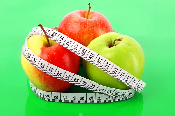 Misura nastro bianco intorno a una mela rossa che rappresenta la dieta — Foto Stock