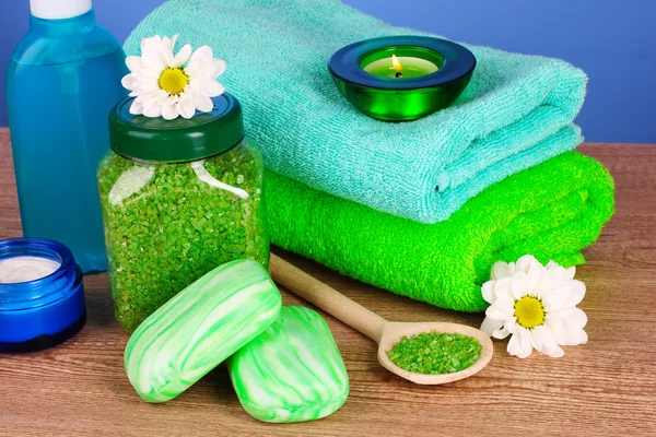 Bath salt, soap and towel on blue background — Stock Photo, Image