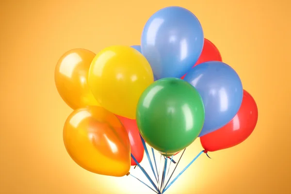 Flying balloons on a yellow background — Stock Photo, Image