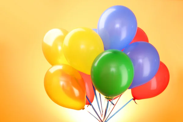 Flying balloons on a yellow background — Stock Photo, Image