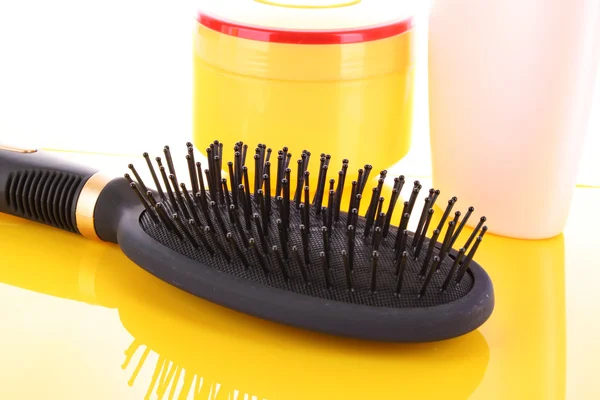 Big black comb on yellow background — Stock Photo, Image