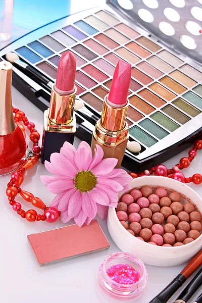 Many colourful woman cosmetics with flower on white white back — Stock Photo, Image