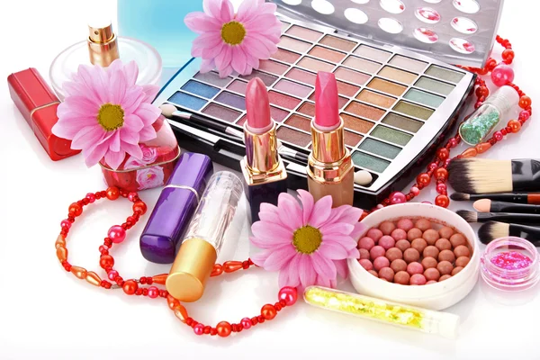 Many colourful woman cosmetics with flower on white white back — Stock Photo, Image