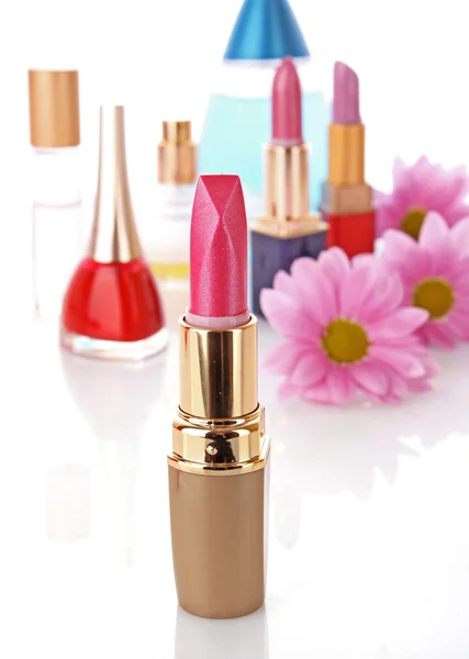 New lipstick on cosmetics and flower background — Stock Photo, Image