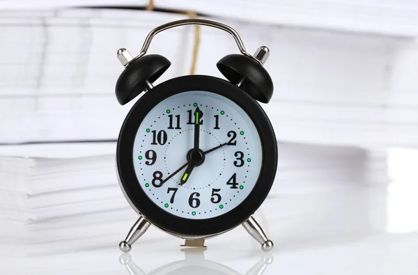 stock image Black alarm clock and documents