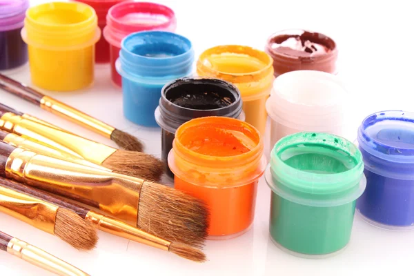 Opened paint buckets colors with paintbrush — Stock Photo, Image
