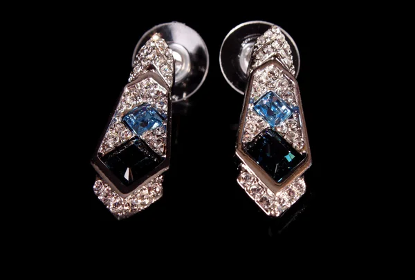 Beautiful earrings with gems on black background Stock Photo