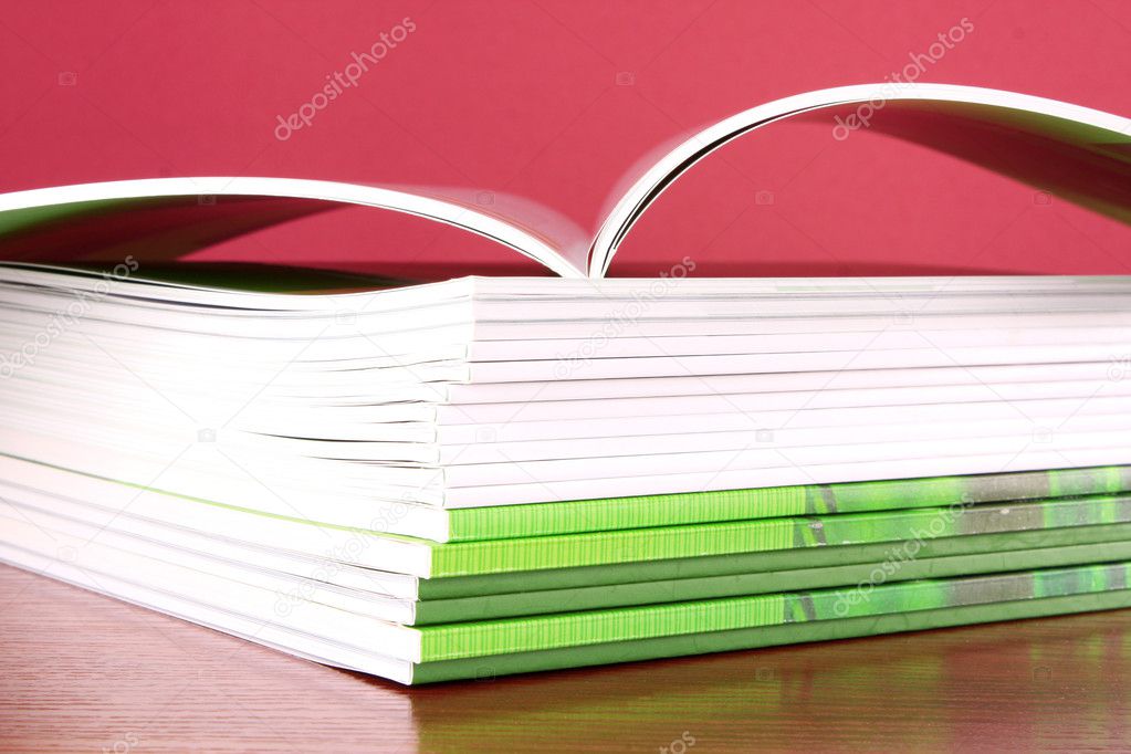 Pile of color magazines on blue background