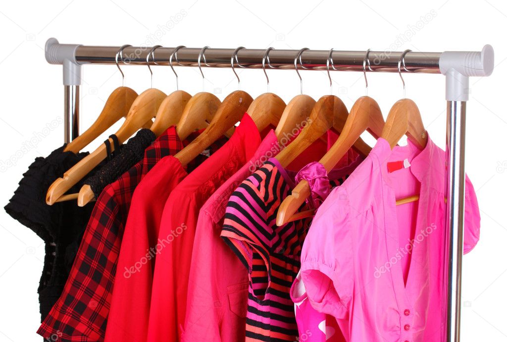 Different clothes on wooden hangers