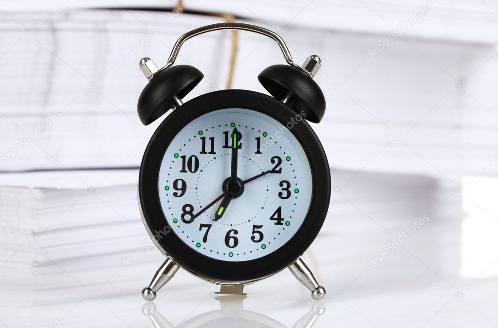 Black alarm clock and documents
