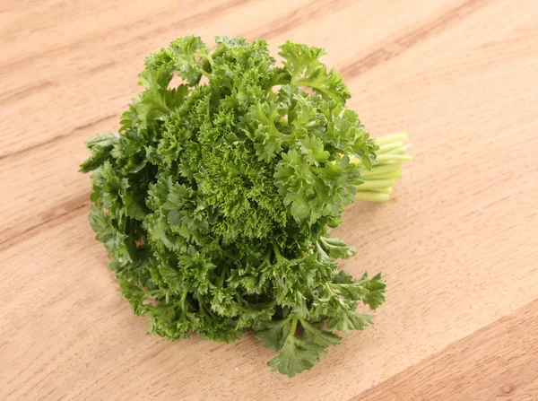Bouquet of parsley on wooden background — Stock Photo, Image