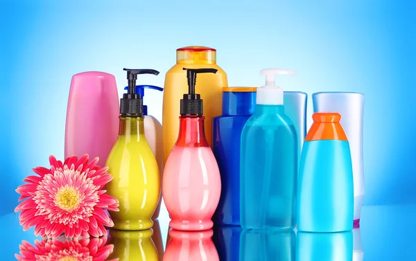 Бутылки для здоровья и косметики на синем фоне с ре — стоковое фото
