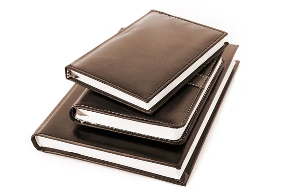Três cadernos pretos sobre fundo branco — Fotografia de Stock