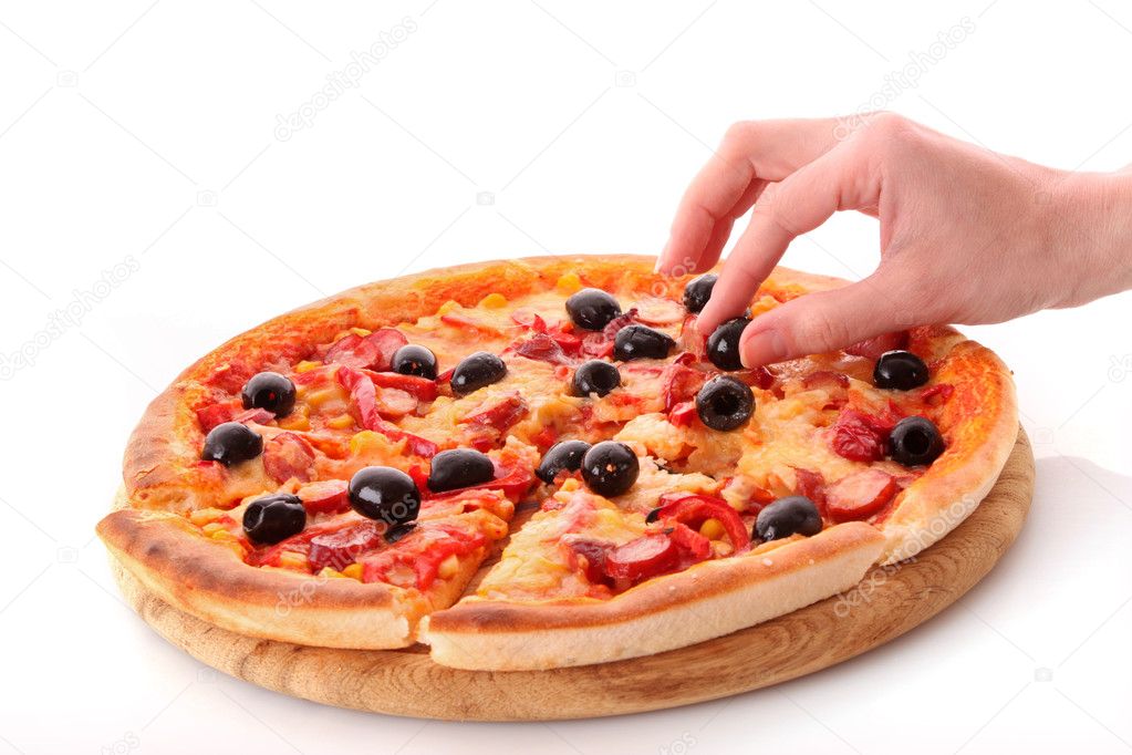 Fingers takes olive from tasty pizza