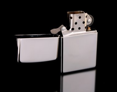 Iron lighter on a black background clipart