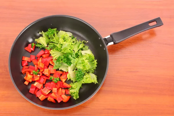 Patelnia z warzywami na stole — Zdjęcie stockowe
