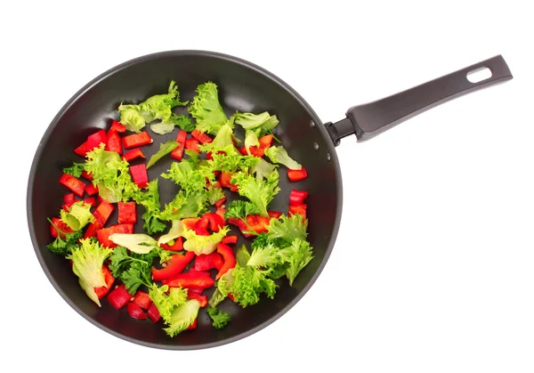 Frying pan with vegetables on white — Stock Photo, Image