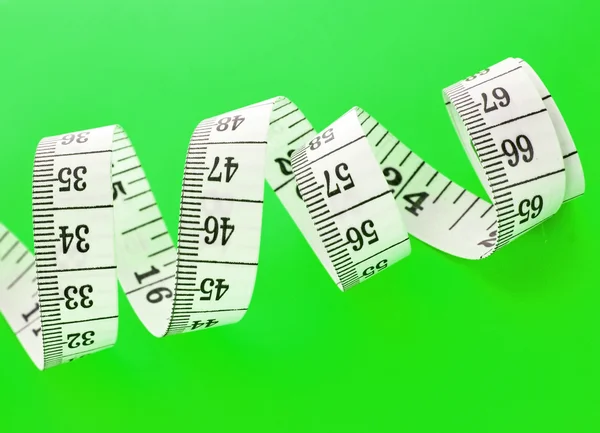 Tape Measure on green background — Stock Photo, Image