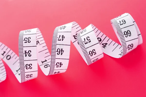Tape Measure on pink background — Stock Photo, Image