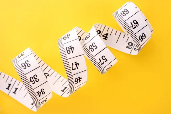 Tape Measure on yellow background — Stock Photo, Image