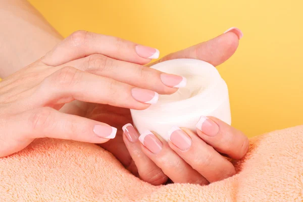 Vrouw aanbrengen crème op haar hand — Stockfoto