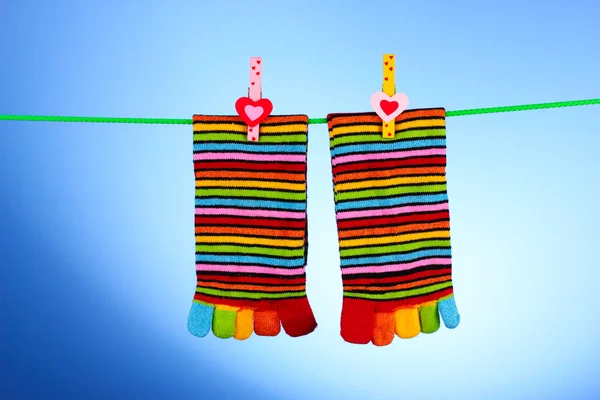 Socks hanging on blue — Stock Photo, Image