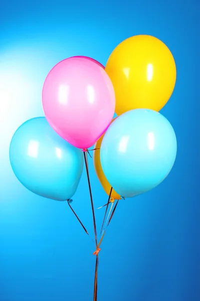 Fliegende Luftballons auf blauem Hintergrund — Stockfoto