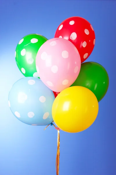 Flygande ballonger med prickiga på blå bakgrund — Stockfoto