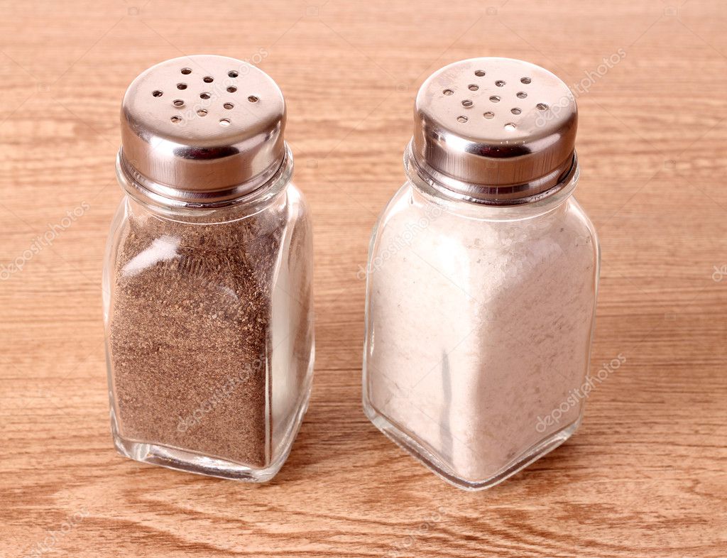 Download - Salt in the salt shaker and pepper in a pepper shaker on a...