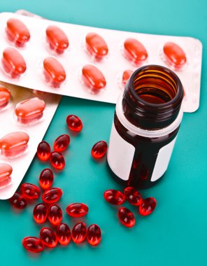 Vitamin mavi bir arka plan üzerinde kırmızı kapsül