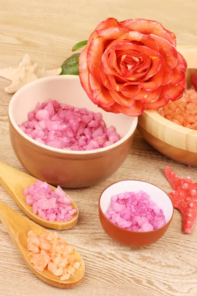 Bath aromatic salt, rose and sea stars on wooden background — Stock Photo, Image
