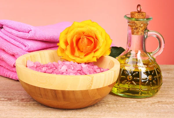 Sea salt, a towel and orange rose on a red background — Stock Photo, Image