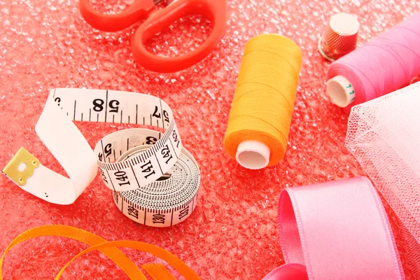 Needle, threads, scissors, ribbons and measuring tape — Stock Photo, Image